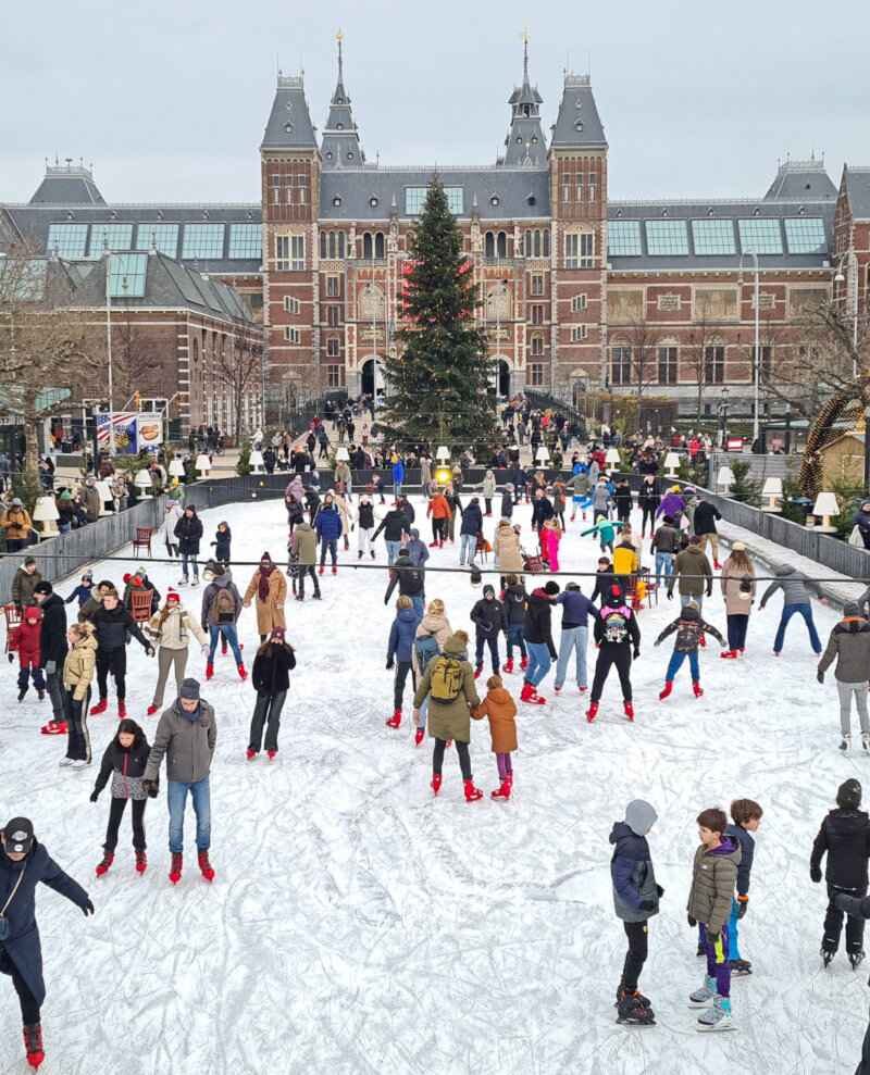 People skating on an ice rink in front of the Rijksmuseum in Amsterdam.